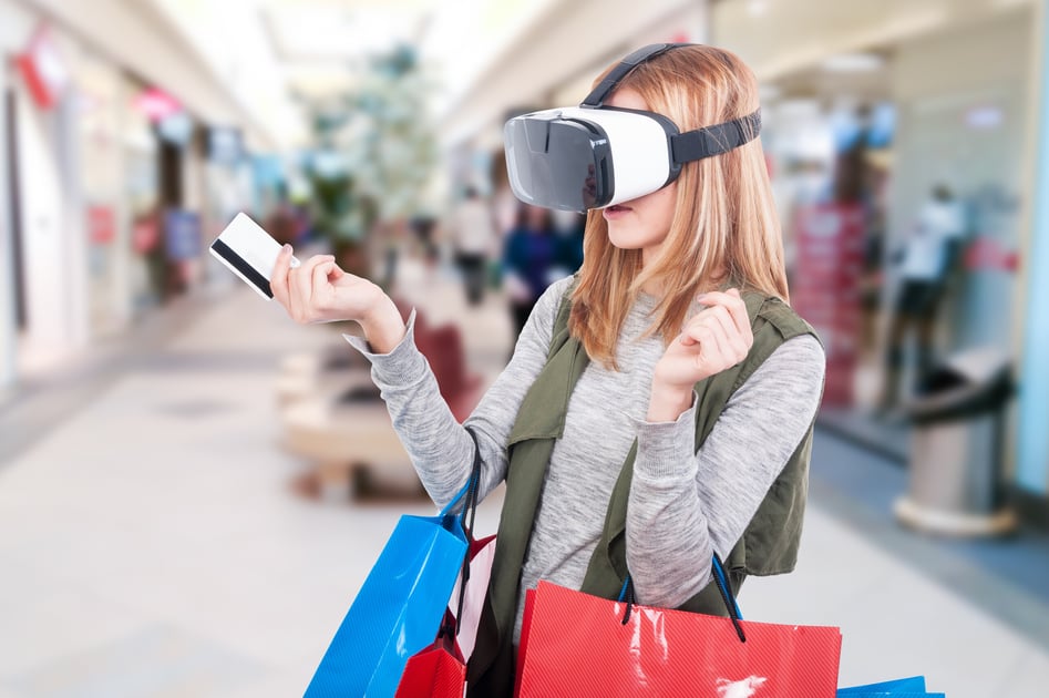 Person wearing VR headset, while holding her credit card and shopping bags