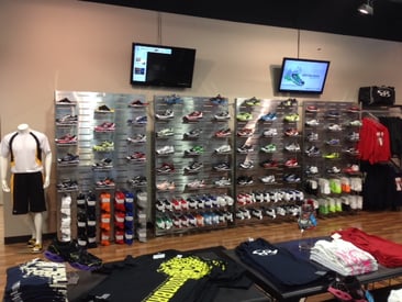 Store displaying shoe wall display with mannequin