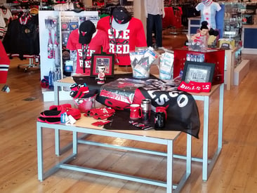 Store displaying nesting table with branded sports attire