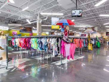 Showing aisles of vibrant clothing racks