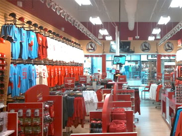 Store displays slatwall with hat and jerseys along with double sided merchandise displays