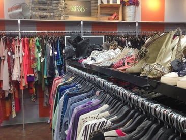 Close up of clothing racks with shelf on top