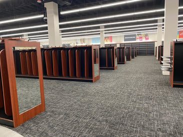 Shoe Show interior with shoe displays and view of shelving units