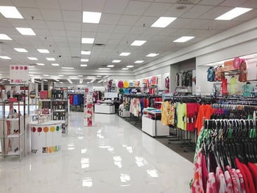 Store displaying open space with multiple clothing racks